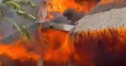 Woman dies after huge fire rips through luxury beach resort as 1,700 tourists evacuated